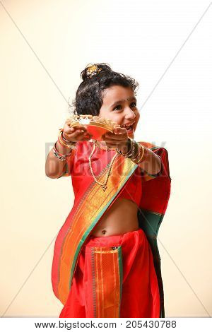 cute indian child in traditional style , posing