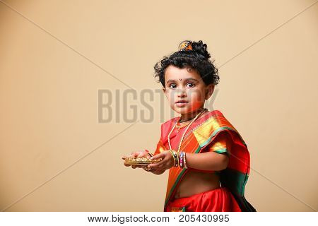 cute indian child in traditional style , posing