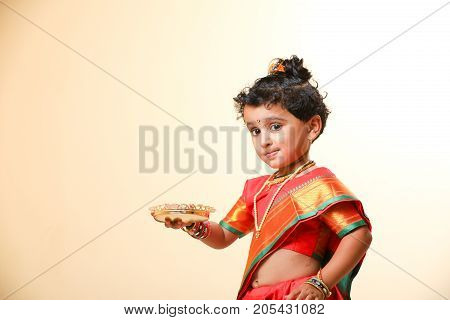 cute indian child in traditional style , posing