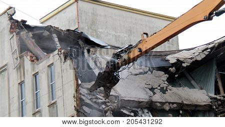 Long Arm of a Demolition Machine Grabbing Concrete.