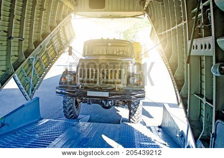 Truck On The Ramp Rides Into The Cargo Area Of The Aircraft