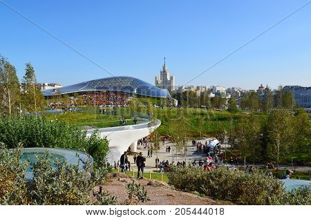 Moscow, Russia - September 23. 2017. People are walking in the park Zaryadye against the background of a glass bark.