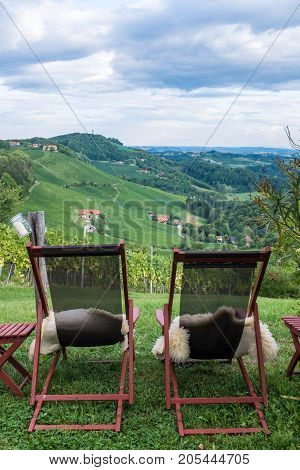 Two loungers with fur for relaxing near vineyard on south Styrian vine route in Austria Europe
