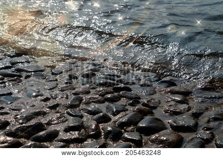 The water of the river Neva washes the stones of the base of Peter-Paul Fortress Fortress in Saint Petersburg, Russia. Backlighting