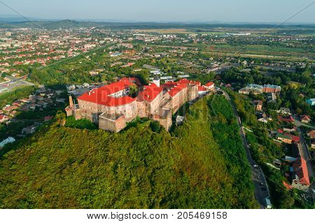 Aerial view of the Majestic Fortress - Palanok Castle towering above the city of Mukacheve, Ukraine.