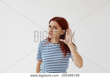 Stay away from me. Headshot of attractive young female with winger eyeliner feeling irritated and annoyed showing stop sign with her palm doesn't want to continue senseless talk. Ban and rejection