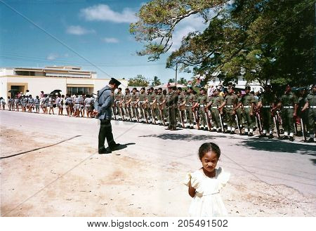 NUKU'ALOFA, TONGATAPU / TONGA - CIRCA 1990: Tongan soldiers stand at attention to watch a parade during a national holiday.