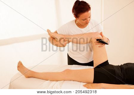 Physiotherapist Doing Tecar Therapy Alterantive Treatment On A Woman Patient