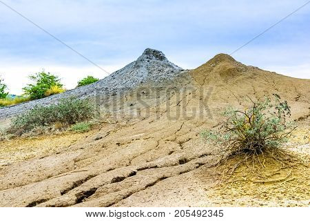 Bubbling mud. Landscape with muddy volcano at sunset - landmark attraction in Buzau, Paclele mari, Romania