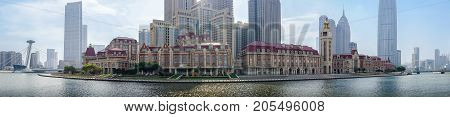 Tianjin, China - Nov 1, 2016: Commercial skyline across the Haihe River. Buildings in contrasting modern and old architectural style. A panorama view from Tianjin Railway Station.