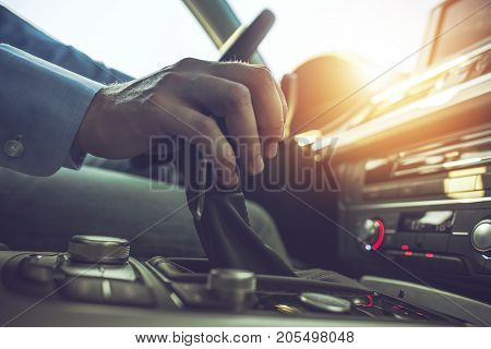 Car Driving Concept. Driver Shifting To Drive Mode. Hand on Transmission Stick Closeup