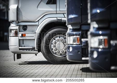 Semi Trucks on the Rest Area Closeup. Transportation and Logistics Photo Concept.