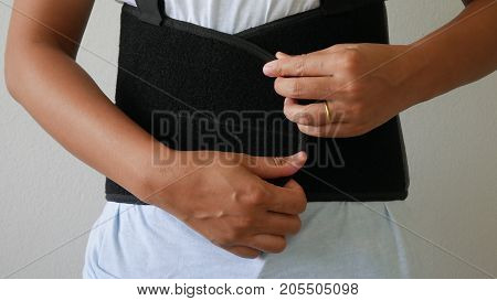 close up patient Lumbar spondylosis with lumbar support on white wall.