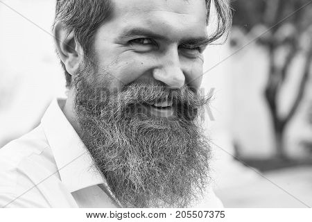 Sexy guy young male model with handsome smiling face and lilac beard posing in white skirt on natural background outdoor