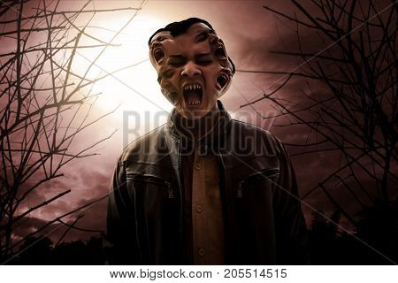 Angry vampire screaming on the forest at night