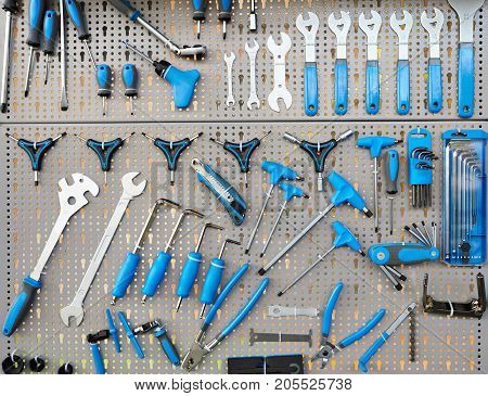 Stand with set tools on bicycle workshop