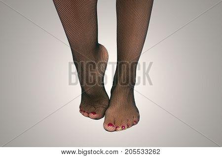 Sexy female legs in fishnet pantyhose stockings standing on toe cap isolated.