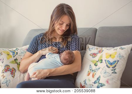 Young Mother Breastfeeding  Her Newborn Baby Boy