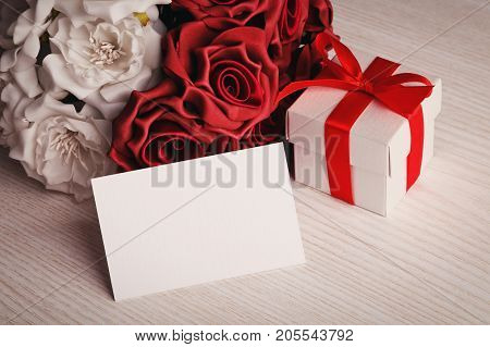 flowers and blank for greeting on a wooden background. place for text