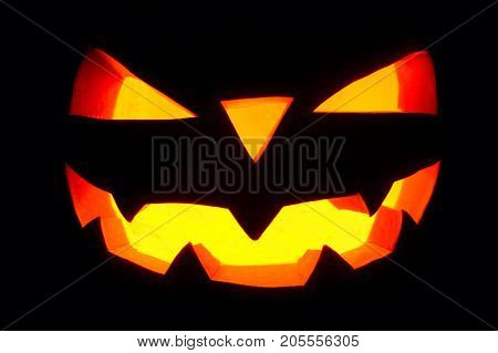 The Concept Of Halloween. The Ghastly, Ghastly Pumpkin Glows With A Fiery Yellow Light. Mystical Jac