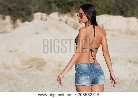 Girl in swimsuit at the sea. High fashion look.glamor beautiful sexy stylish blond. Caucasian young woman model.