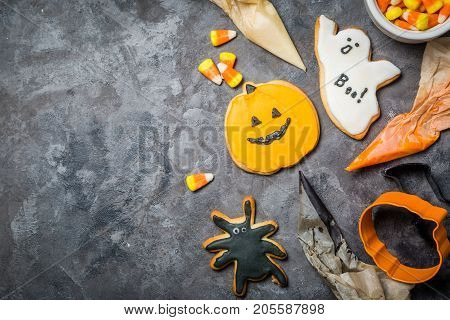Halloween concept - baking background with cookies and candies, cutters, rustic background