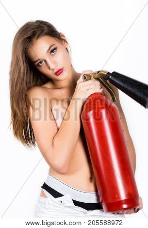 Sexy sensual female firefighter with a red fire extinguisher.