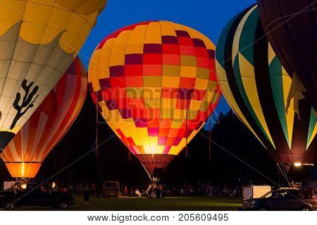 Seymour WI - August 12 2017: Hot air balloon glow during Hamburger Fest in Seymour WI. Hot air balloons are an integral part of the annual festival which celebrates Seymour as the birthplace of the hamburger.