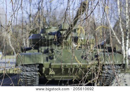 The tank lurked in ambush in the forest.