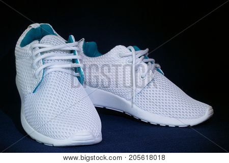 White training sneakers on dark background isolated