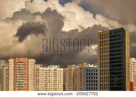 Storm clouds over modern houses of the big city
