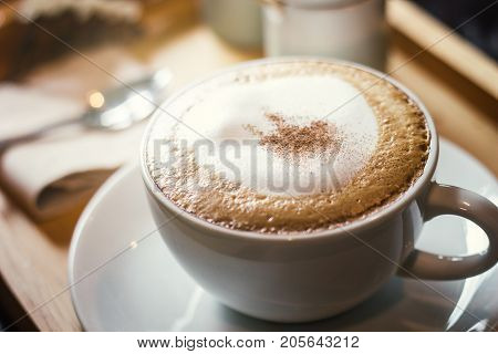 Soft focus on capuccino coffee cup coffee for background - vintage effect process picture