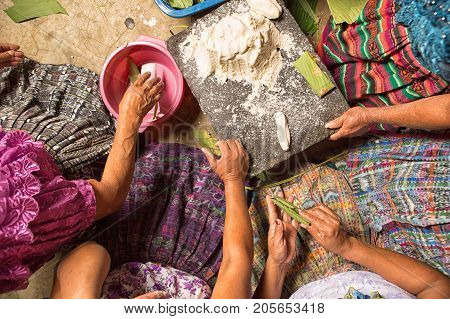 January 20, 2015 San Pedro La Laguna, Guatemala: Mayan Women In Traditional Wear Preparing Food Toge