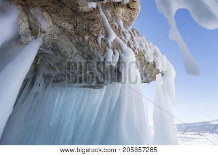 icicles on stone of Oltrek island Lake Baikal. Winter