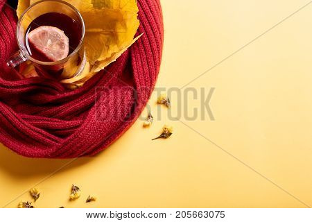 Cup of black tea on the yellow background. Close-up of autumn mood. Copy space.