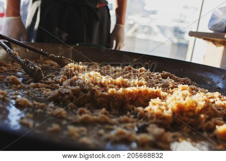Freshly prepared juicy traditional Bavarian cabbage in a large frying pan during the octoberfest season. Soft focus and backlight.