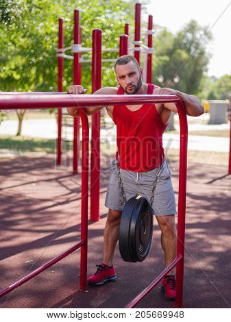 Full length of sporty and healthy muscular man exercising outdoors. Sexy young man with a muscular body on a natural background. Strong and perfect male body.