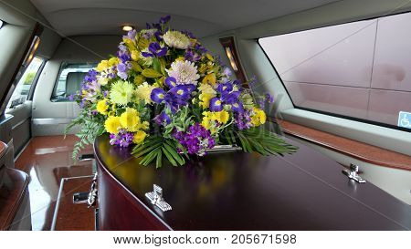 closeup shot of a colorful casket in a hearse or chapel before funeral or burial at cemetery