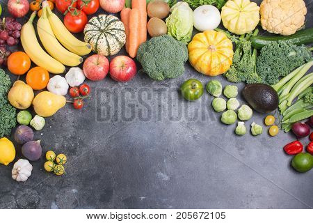 Healthy eating, colorful rainbow vegetables and fruits on the dark grey background, copy space for text below, selective focus