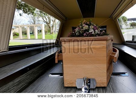 closeup shot of a colorful casket in a hearse or chapel before funeral or burial at cemetery