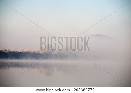 Morning on the river early morning reeds mist fog and water surface on the river