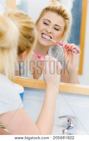 Woman Brushing Cleaning Teeth In Bathroom