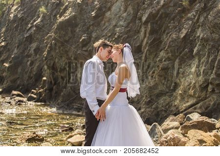 Just married couple embraced on nature. Bride and groom.