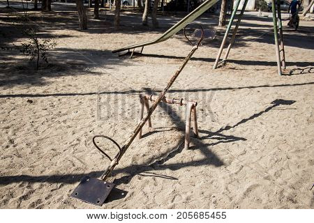 Old metal swing in an abandoned park for children