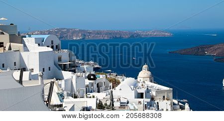 View of Caldera from town of Fira on the Island of Santorini Greece against clear blue sky and sea.