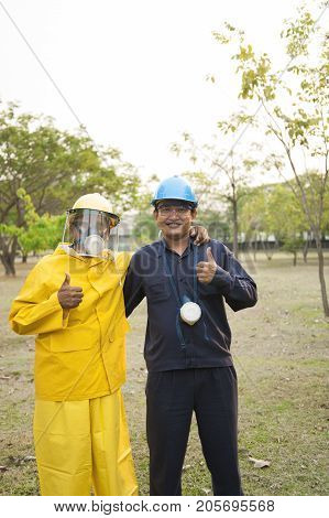 Padaeng industry Mae Sot Tak Thailand February20 2013 : Zinc mine. Two men in employee uniform hugging and showing thumbs up.