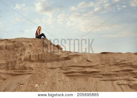Woman sits high on the mountain and is plunged into dreams she thinks.