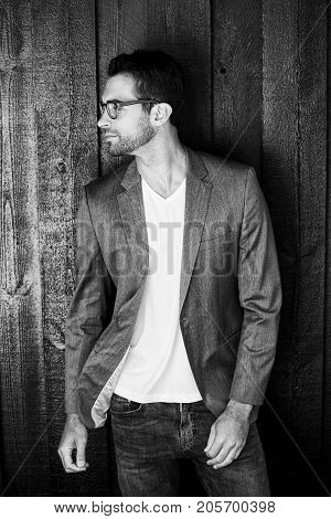 Stubble guy in suit jacket looking away