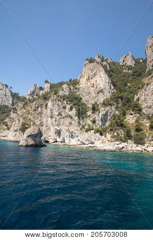 View from the boat on the cliff coast of Capri Island Italy