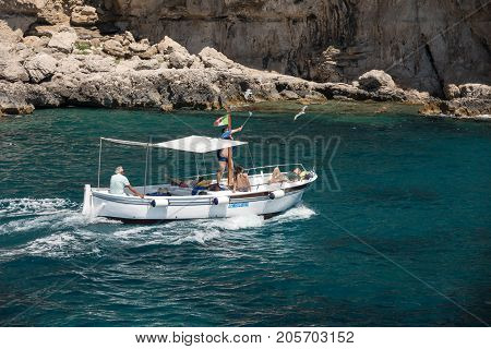 CAPRI ITALY - JUNE 13 2017: Boats with tourists near Grotta Bianca and Grotta Meravigliosa Capri iATLY
